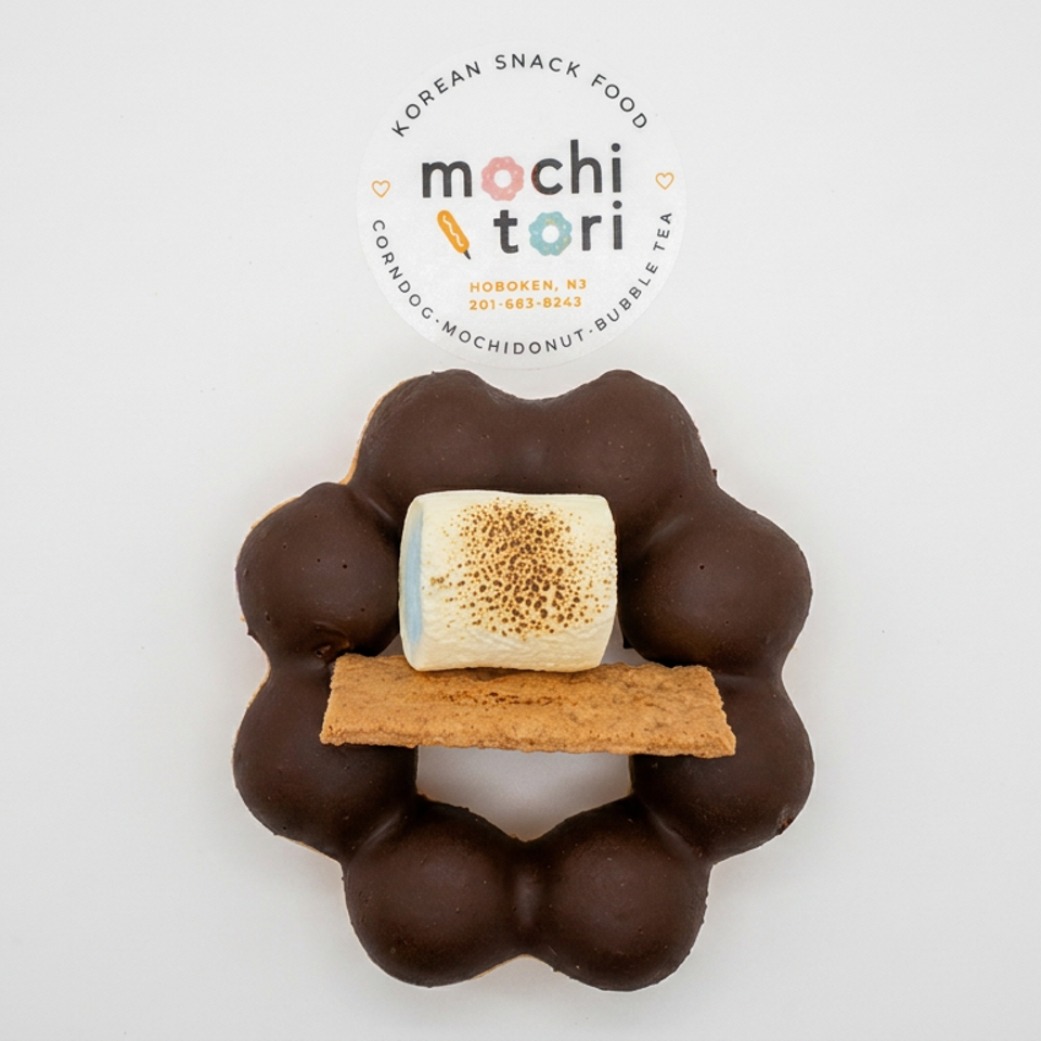 Chocolate-coated mochi ring topped with a graham cracker and toasted marshmallow, displayed beneath Mochi Tori branding.